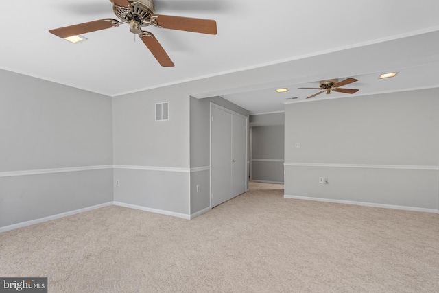 carpeted empty room featuring ornamental molding and ceiling fan