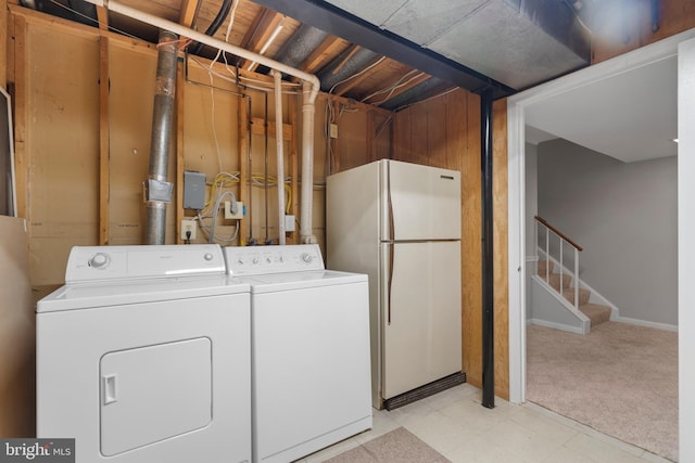 clothes washing area with washing machine and dryer