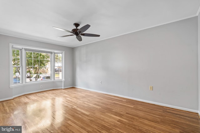 empty room with crown molding, ceiling fan, and light wood-type flooring