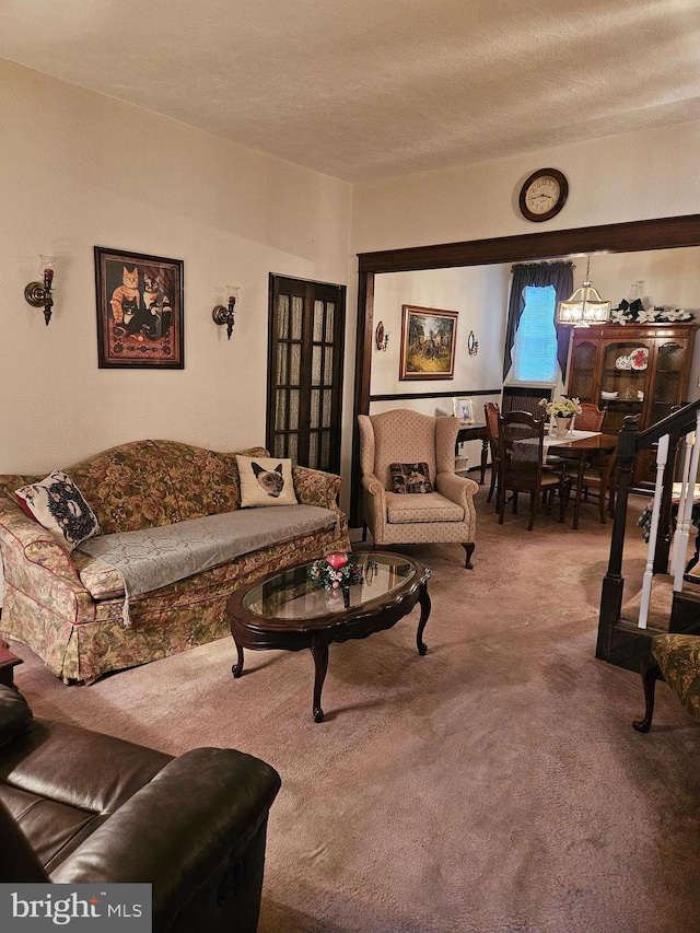 carpeted living room featuring a textured ceiling