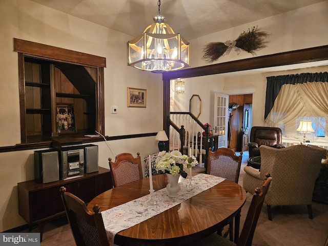 carpeted dining room with a notable chandelier