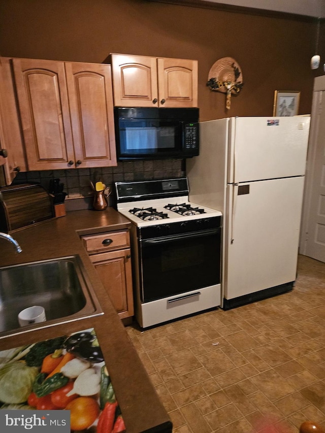 kitchen with tasteful backsplash, white appliances, and sink