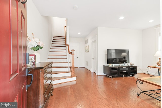 entryway featuring stairs, recessed lighting, visible vents, and wood finished floors