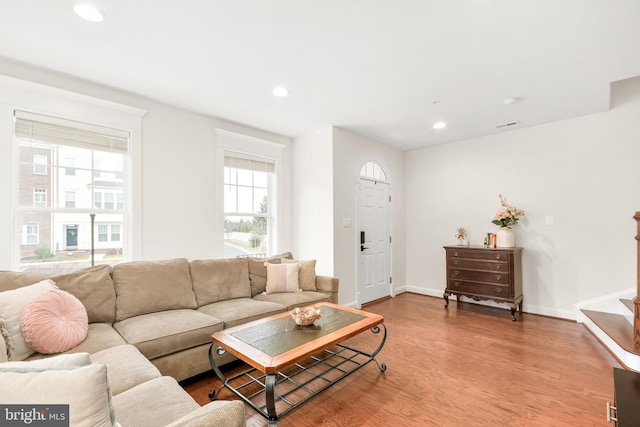 living area with stairs, baseboards, wood finished floors, and recessed lighting