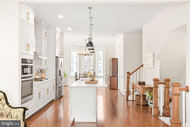 kitchen with light countertops, appliances with stainless steel finishes, and hardwood / wood-style floors