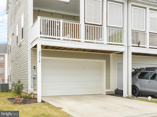 garage with central AC and driveway