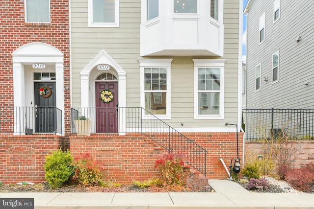 doorway to property featuring brick siding