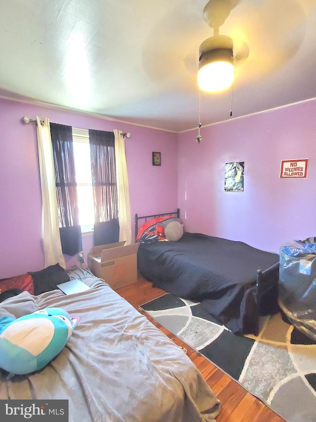 bedroom featuring hardwood / wood-style floors and ceiling fan