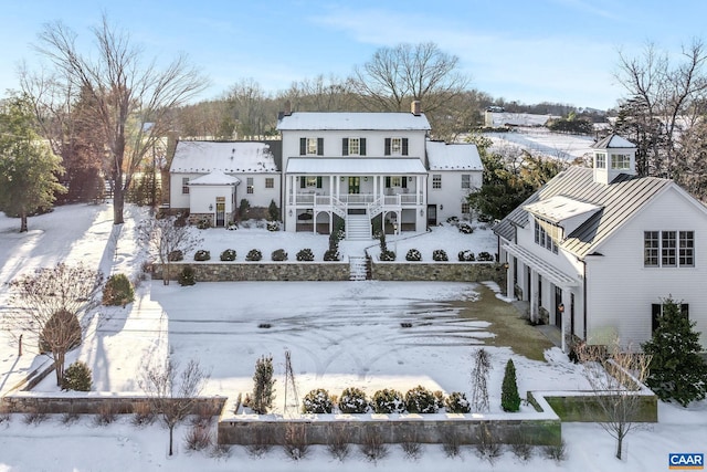 snow covered house with covered porch