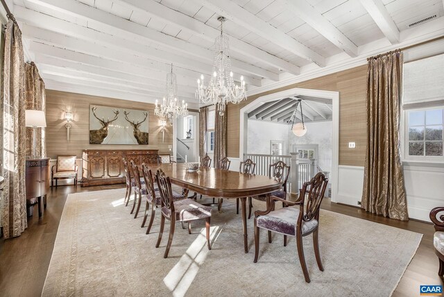 dining room with beamed ceiling, wood ceiling, an inviting chandelier, and hardwood / wood-style flooring