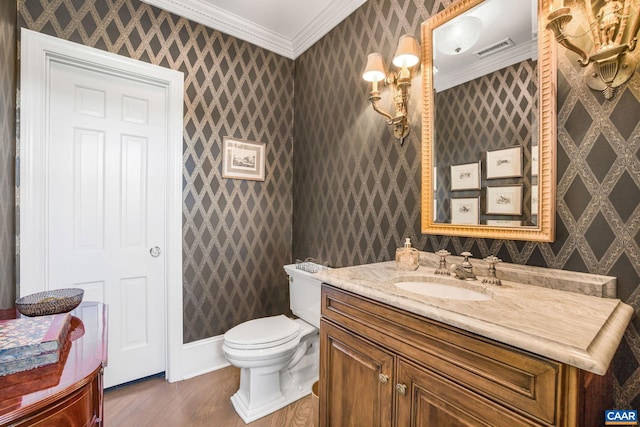 bathroom featuring crown molding, wood-type flooring, vanity, and toilet