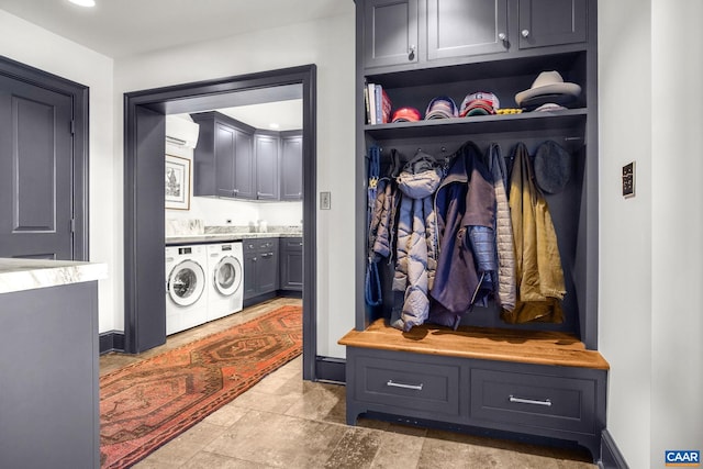 mudroom with washer and clothes dryer and a wall unit AC