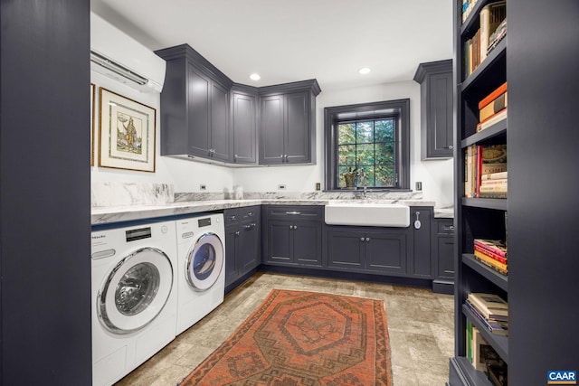 washroom featuring cabinets, independent washer and dryer, sink, and an AC wall unit