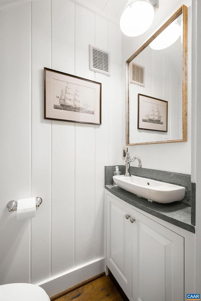 bathroom with vanity and hardwood / wood-style floors