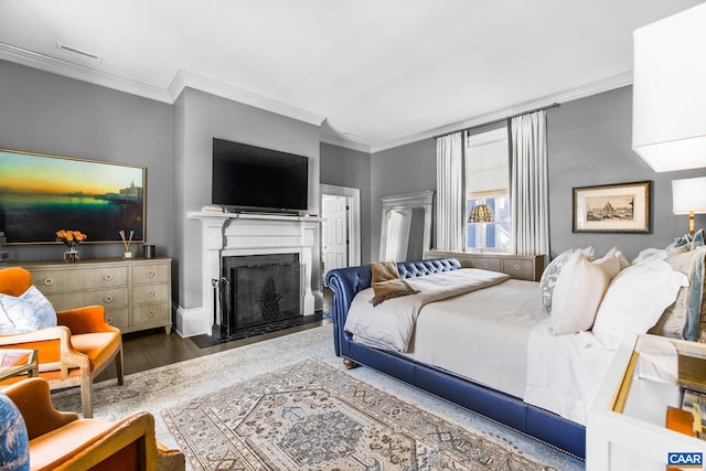 bedroom featuring crown molding and dark hardwood / wood-style flooring