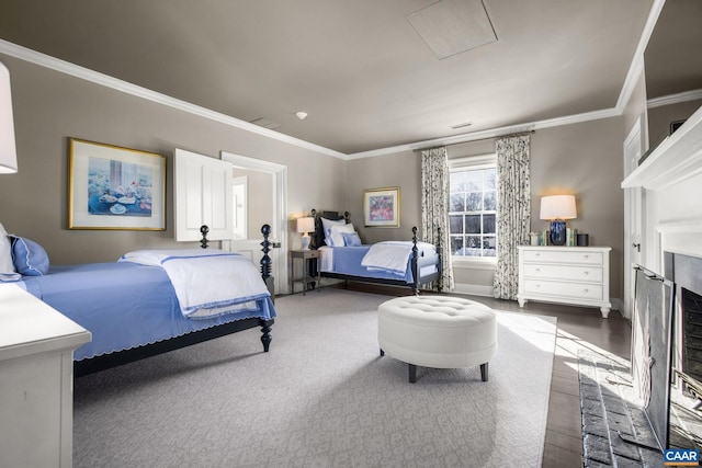 bedroom featuring ornamental molding, wood-type flooring, and a fireplace