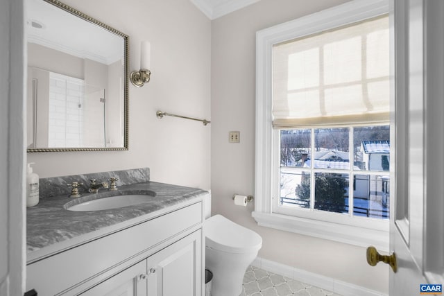 bathroom with ornamental molding, vanity, and toilet