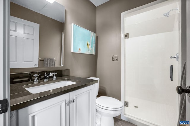 bathroom featuring vanity, tile patterned flooring, a shower with door, and toilet