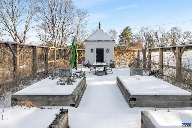 snow covered deck featuring a shed