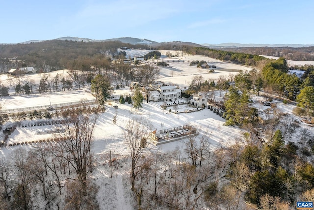 snowy aerial view with a mountain view