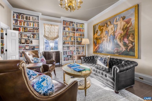 living area featuring hardwood / wood-style flooring, ornamental molding, built in shelves, and a notable chandelier