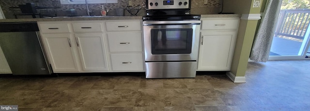 kitchen featuring a sink, white cabinetry, stainless steel appliances, and decorative backsplash