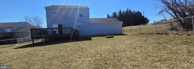 back of house with a fenced backyard, a yard, and a deck