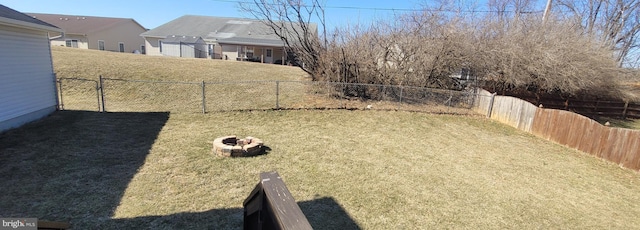 view of yard featuring a fire pit and a fenced backyard