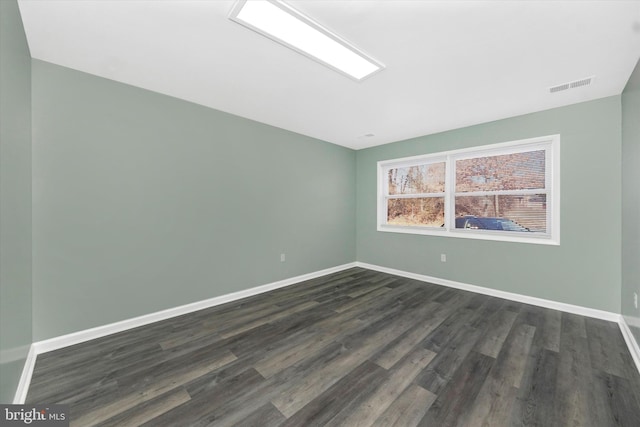 empty room with dark hardwood / wood-style floors