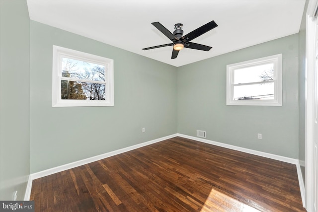 unfurnished room featuring dark wood-type flooring and ceiling fan