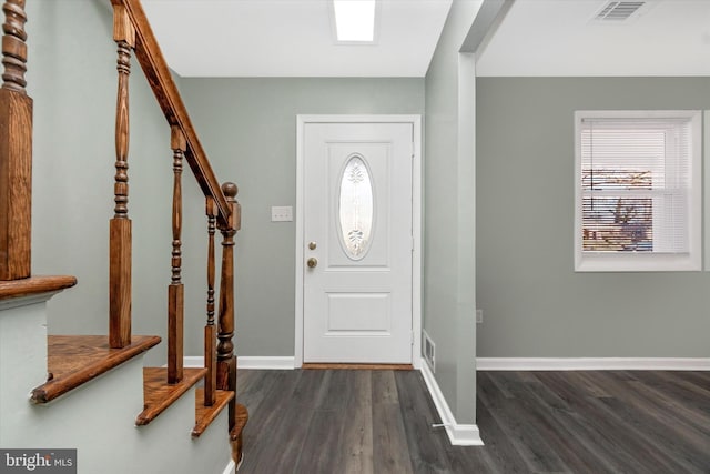 foyer with dark wood-type flooring and a healthy amount of sunlight