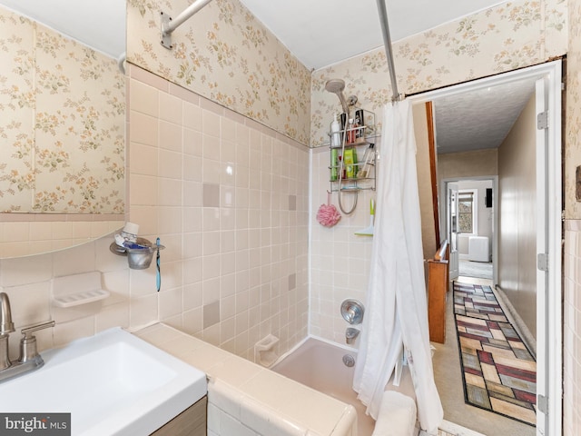 bathroom featuring shower / bath combo, tile walls, and vanity