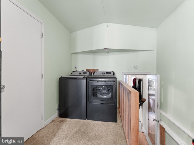 laundry room featuring light carpet and washer and clothes dryer