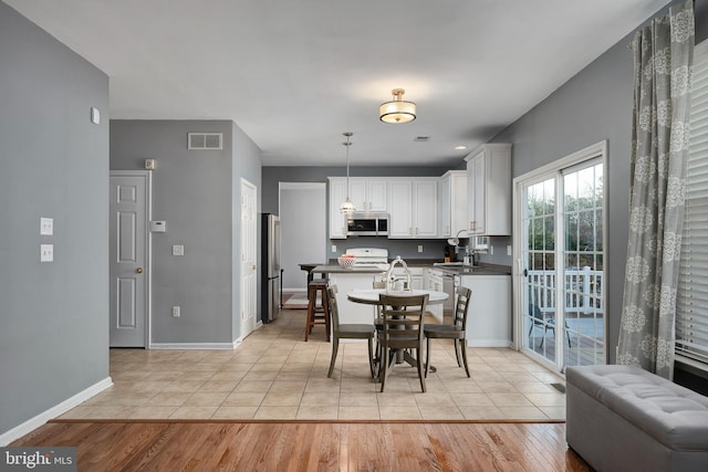 dining space with sink and light tile patterned flooring