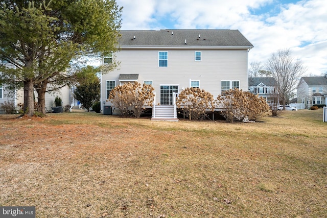 back of house with a lawn