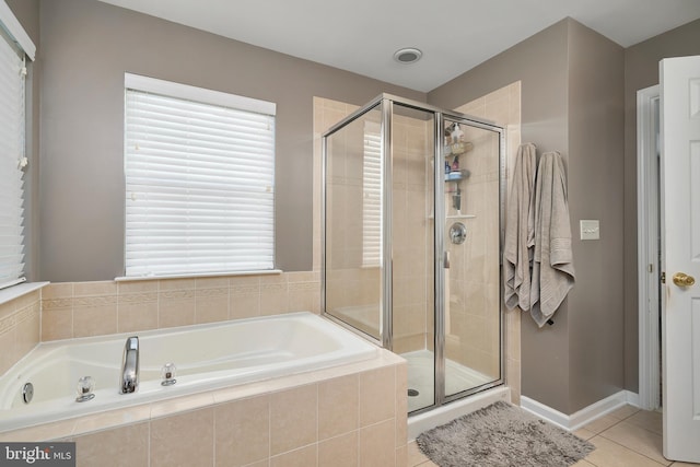 bathroom featuring tile patterned floors and independent shower and bath