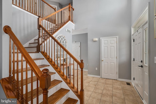 tiled entrance foyer with a high ceiling