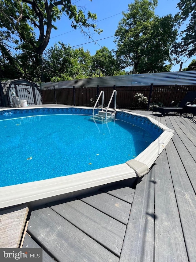 view of pool with a wooden deck