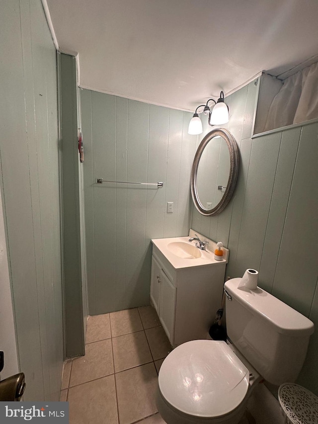 bathroom featuring vanity, tile patterned floors, and toilet