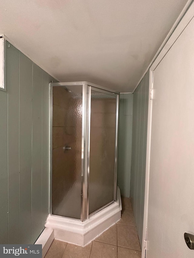 bathroom featuring tile patterned flooring and a shower with door