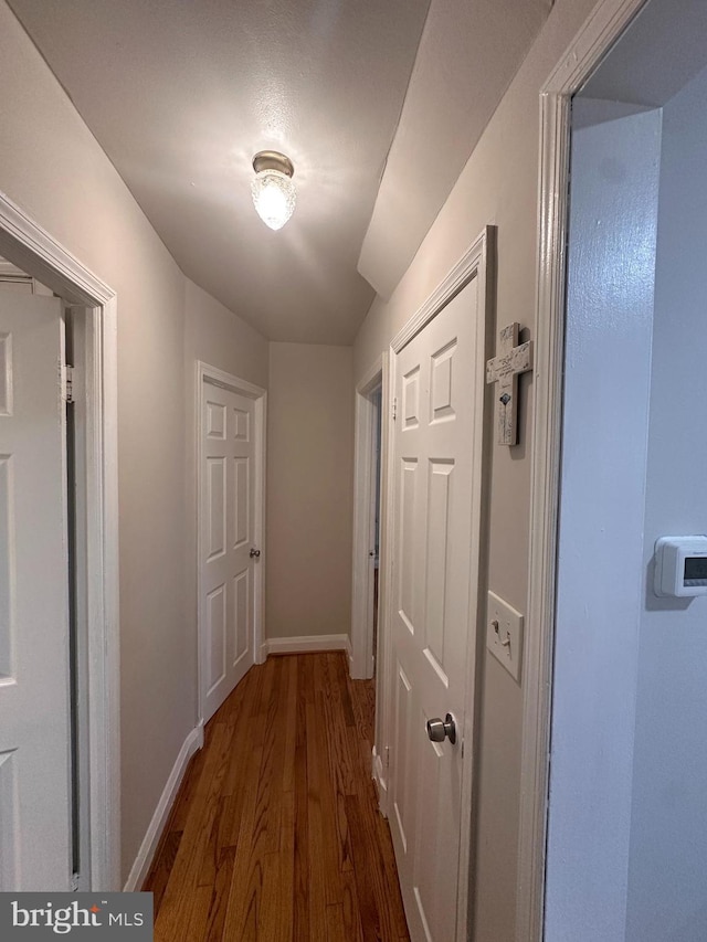 hallway with dark hardwood / wood-style floors