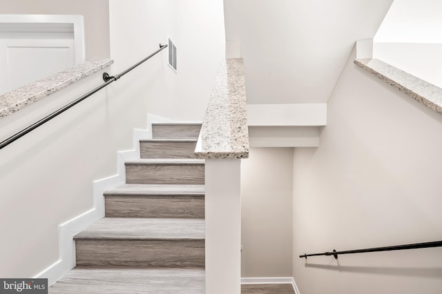 stairs featuring wood-type flooring