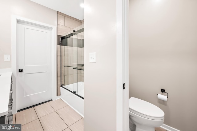 full bathroom featuring toilet, vanity, and shower / bath combination with glass door