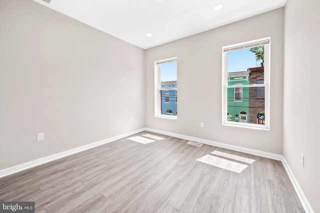 spare room with plenty of natural light and light wood-type flooring