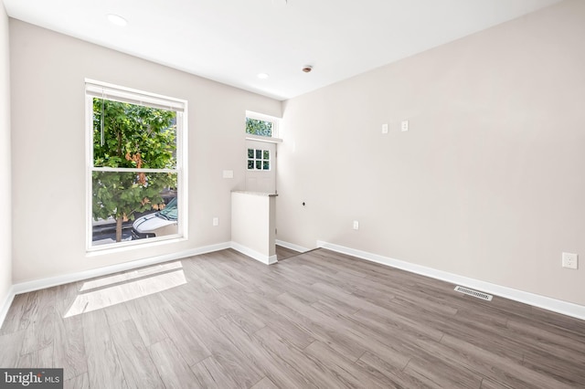 spare room featuring light hardwood / wood-style flooring