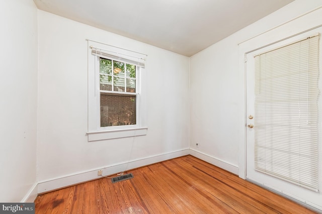 spare room featuring hardwood / wood-style flooring