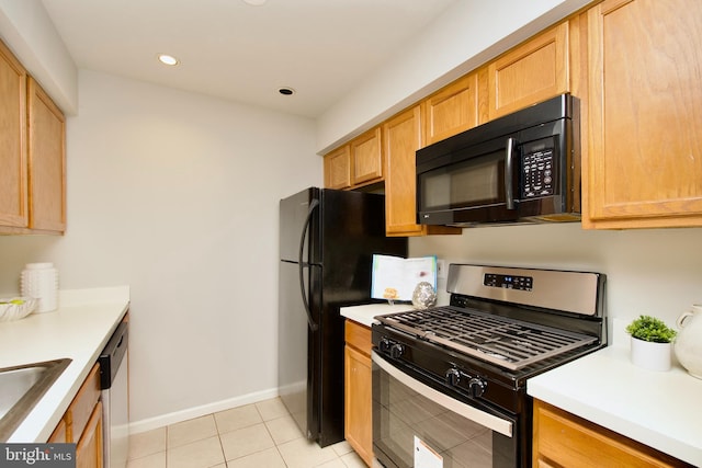 kitchen featuring light tile patterned flooring and appliances with stainless steel finishes