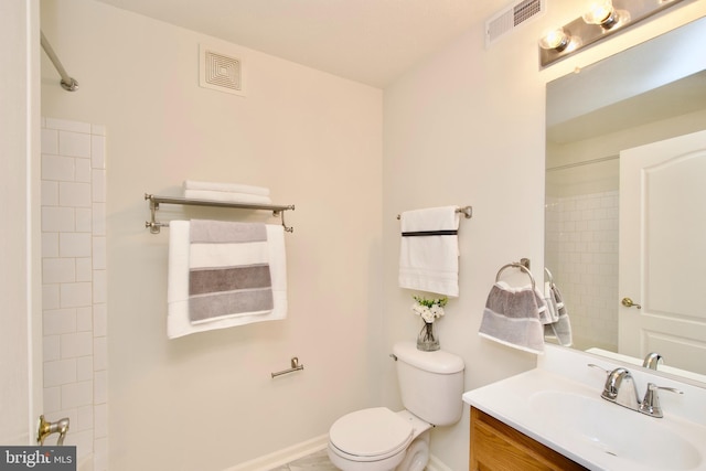 bathroom with a shower, vanity, and toilet