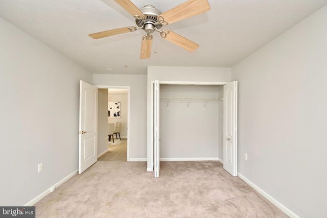 unfurnished bedroom with light carpet, a closet, and ceiling fan