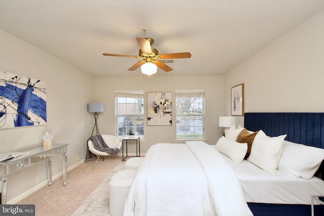 bedroom featuring light colored carpet and ceiling fan